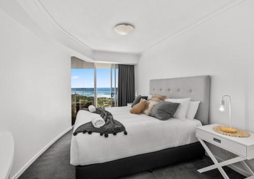 玛志洛Sensational Sebel Ocean View 2 Bedroom Apartment的白色卧室配有一张大床和一张书桌
