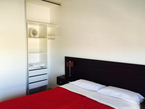 卡尼乌拉斯Apart Hotel Cañuelas的一间卧室配有一张带红色毯子的床
