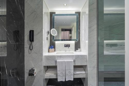 凯里尼亚Merit Park Hotel Casino & SPA的一间带水槽和镜子的浴室