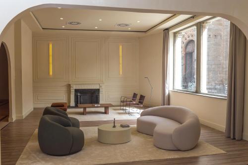 阿维拉瓦尔德拉巴内斯皇宫酒店的客厅配有两把椅子和壁炉
