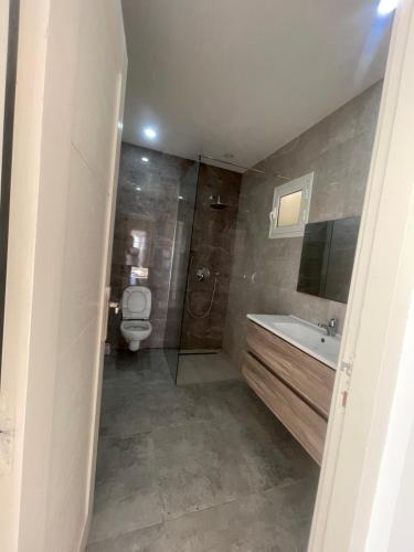 TemlaleVilla Ahmed的浴室配有卫生间、盥洗盆和淋浴。