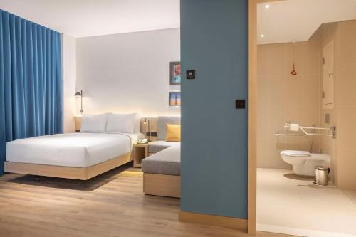 科威特Hampton By Hilton Kuwait Salmiya的酒店客房设有一张床和一个卫生间。