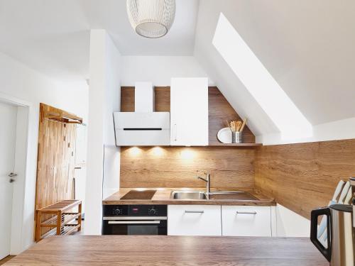 巴特阿罗尔森Ferienhaus 88的厨房配有白色橱柜和水槽