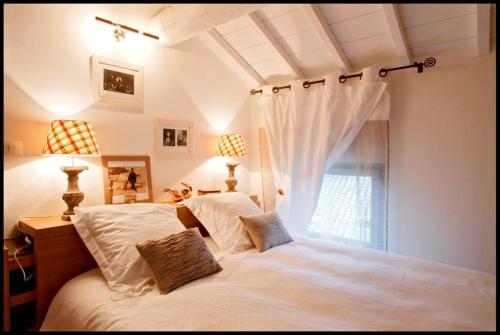 于泽斯Maison De La Bourgade的卧室配有一张大白色床和窗户
