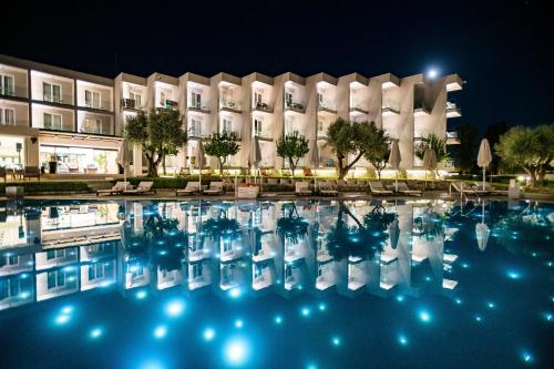 埃雷特里亚Amaronda Resort & Spa Eretria的晚上在酒店前面的一个游泳池