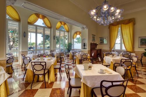 阿伦扎诺埃纳酒店的一间带桌椅和吊灯的餐厅