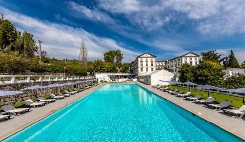 卡尔达斯达费尔盖拉达斯卡尔达斯达菲尔古拉大酒店的一个带躺椅的游泳池和一间酒店