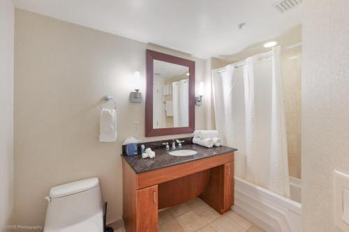 阳光岛滩15th Floor Luxury Suite at Trump Int Resort的一间带水槽、镜子和卫生间的浴室