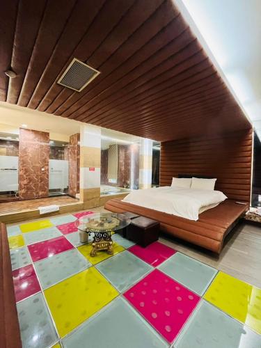 台北沃客商旅 承德馆的一间卧室设有一张床,铺有色彩缤纷的地板。