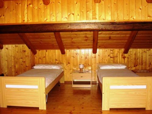 拉比Baita Misseroni Quadrilocale的木墙客房的两张床