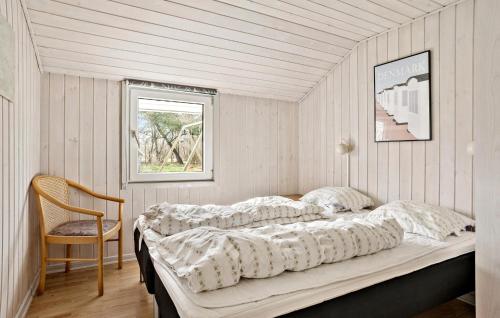 北内伯尔Nice Home In Nrre Nebel With Sauna的一张位于带椅子和窗户的房间的床铺