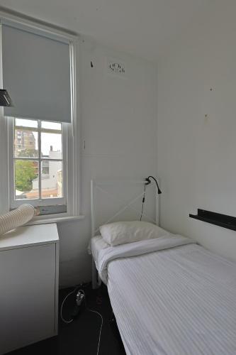 悉尼VENUS Potts Point - FEMALE ONLY HOSTEL - Long stay negotiable的一间小卧室,配有床和窗户