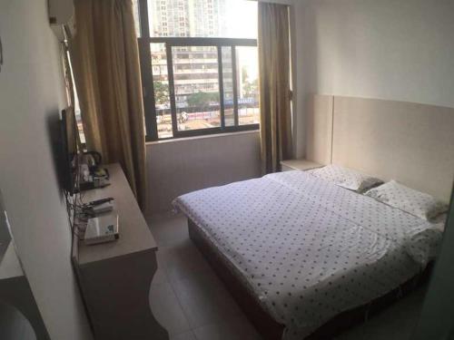 深圳七橙酒店(深圳燕南地铁站华强北店)的一间小卧室,配有床和窗户