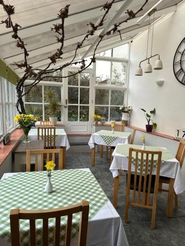 巴恩斯特珀尔斯平尼旅馆的用餐室设有桌椅和窗户。