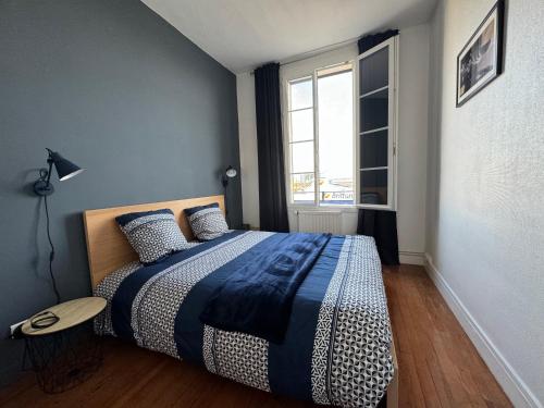 勒阿弗尔"L'amarrage" 2 chambres Perret Pleine Vue Mer的一间卧室配有一张带蓝白色毯子的床