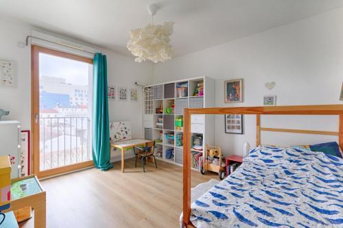 奥贝维利埃Résidor - Lumineux appartement的一间卧室配有一张床、一张书桌和一个窗户。