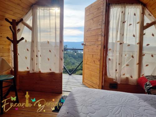 瓜塔维塔Encanto Dorado的一间卧室设有一张床,享有阳台的景色