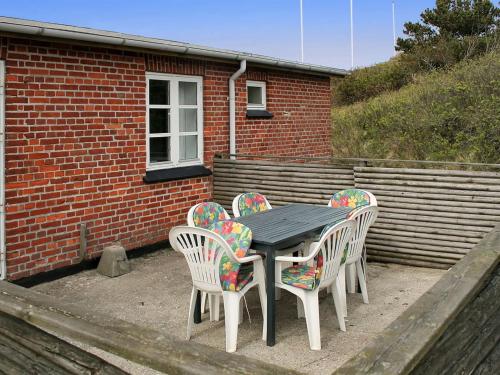 凡岛Apartment Withar - all inclusive - 800m from the sea by Interhome的砖砌建筑前的一张桌子和四把椅子