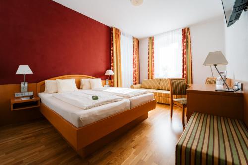 Konnersreuth维西斯罗斯酒店的酒店客房,配有床和沙发