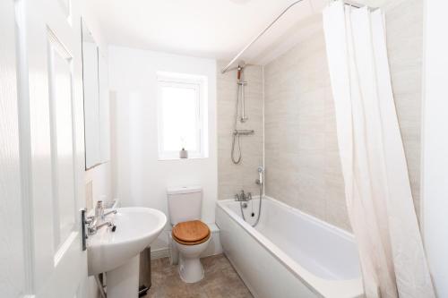 曼彻斯特Spacious 3BR House with Garden & Free Parking的白色的浴室设有浴缸、卫生间和水槽。
