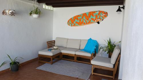 蒂纳霍Casa Mar Azul.的客厅配有沙发和冲浪板。