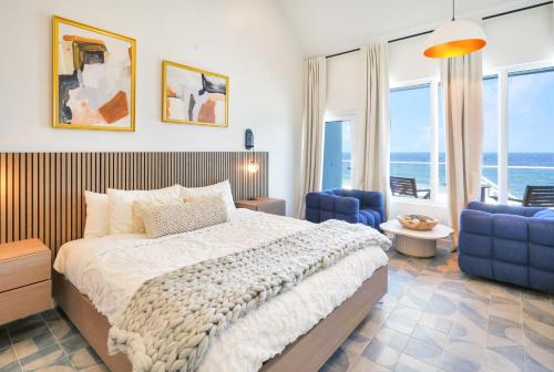 西湾Cobalt Coast Resort的一间卧室配有一张大床和蓝色的椅子