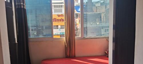 PrayagrajSharma atithi bhavan的窗口前的红色座位开窗