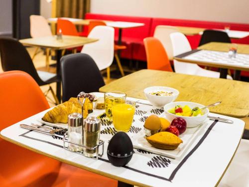 波尔多波尔多市中心圣让车站欧洲大西洋宜必思酒店的桌上的食品托盘,包括水果和果汁