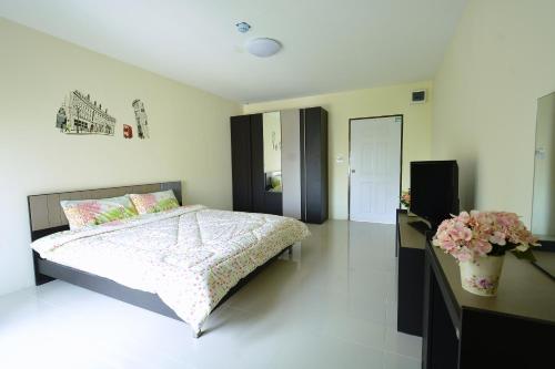曼谷42普拉瑟公寓的一间卧室配有一张带鲜花的大床