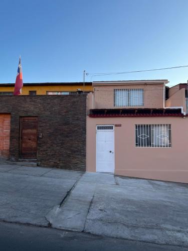 安托法加斯塔Casa Central, Amplia y Cómoda的粉红色的建筑,设有白色的门和车库