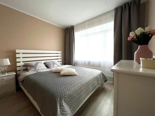 派尔努Pärnu Beach Apartment的一间卧室,床上放着花瓶