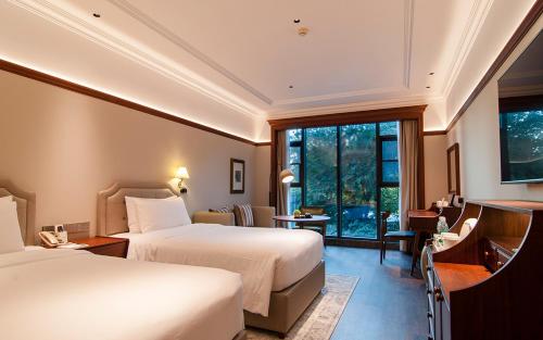 武汉武汉光谷皇家格雷斯大酒店的酒店客房设有两张床和窗户。