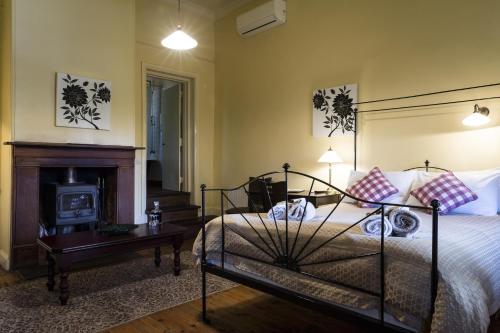 Auburn旭日酒店 的一间卧室配有一张床和一个壁炉