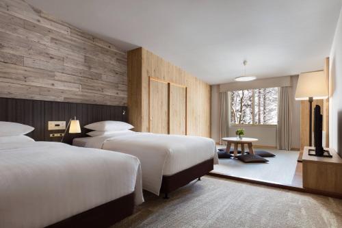白马村Courtyard by Marriott Hakuba的酒店客房设有两张床和窗户。