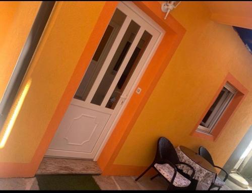 采蒂涅Apartman Petar & Petra的橙色的房间,设有门和椅子