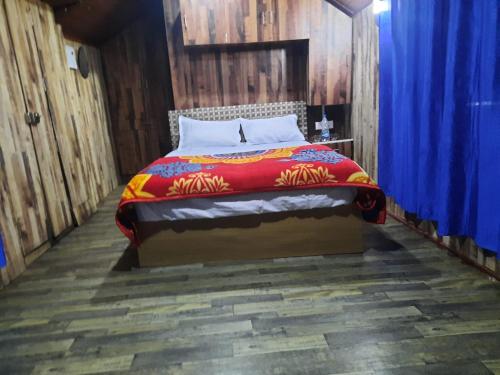 蒙纳Tree House Munnar的蓝色窗帘的房间的一张床位