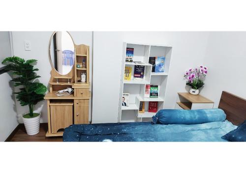 Dĩ AnLuxury Apartment - Charm Ruby, Di An的一间卧室配有蓝色的床和镜子