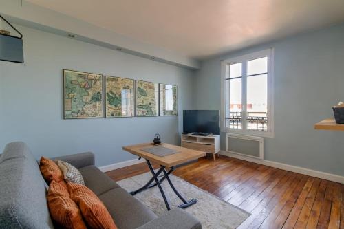 布洛涅-比扬古Charming apartment with view in Boulogne - Welkeys的客厅配有沙发和桌子