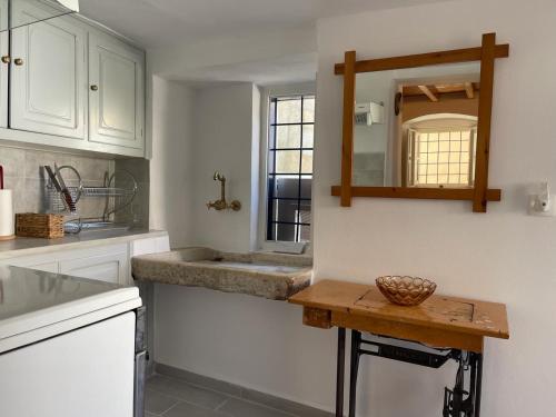 伊兹拉Lemon House的厨房配有水槽和墙上的镜子