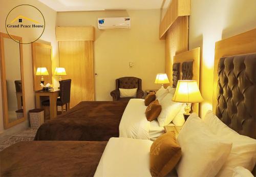 伊斯兰堡Grand Peace House II的酒店客房配有两张床和一张书桌