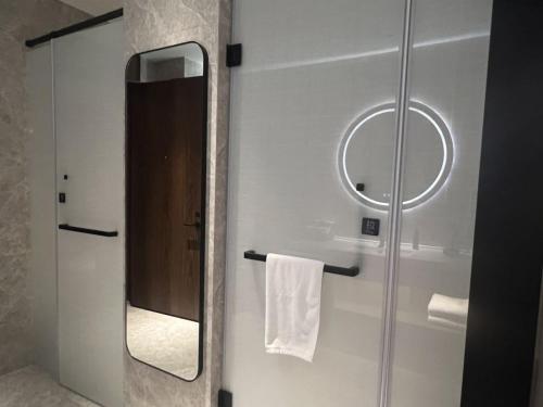 深圳深圳福田CBD逸扉酒店的一间带镜子和毛巾的浴室