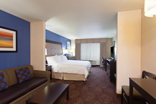 塔科马塔科马市中心智选假日套房酒店的酒店客房,配有床和沙发