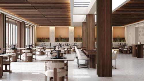 希俄斯PEARL ISLAND CHIOS HOTEL & SPA的餐厅设有桌椅和窗户。