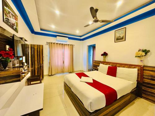 拜拉哈瓦Sun Star International Hotel 24/7的一间卧室配有一张带红色和白色床单的大床