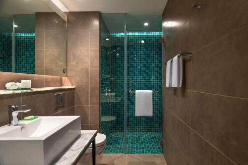 卡兰古特Hyatt Centric Candolim Goa的带淋浴、水槽和卫生间的浴室