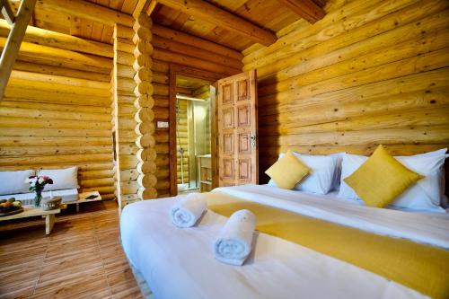 MayrūbāWood Hills Hotel & Resort的小木屋内一间卧室,配有一张床