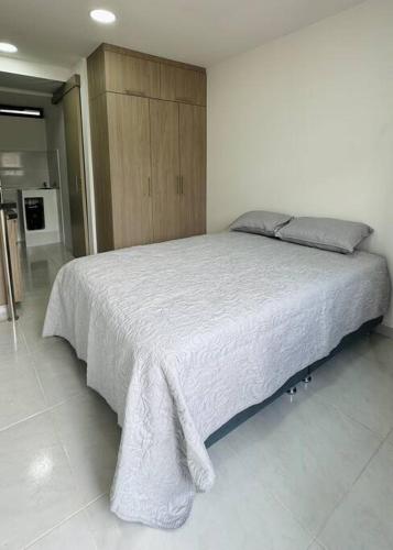弗洛伦西亚Loft con aire acondicionado的一间卧室配有一张带白色毯子的大床