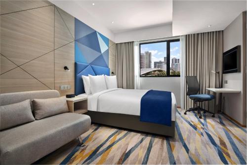 新加坡Holiday Inn Express Singapore Serangoon, an IHG Hotel的酒店客房,配有床和沙发