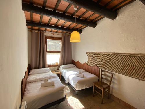 卡斯特罗·德波利亚斯Yeguada Senillosa - Turismo Rural的客房设有两张床和窗户。