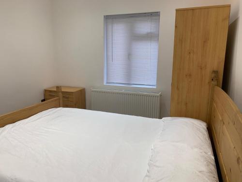 伦敦Private room, renovated with large size white desk In SE9 6PG的卧室配有白色的床和窗户。